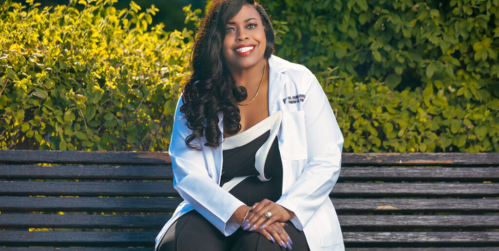 Smiling woman in white coat on bench